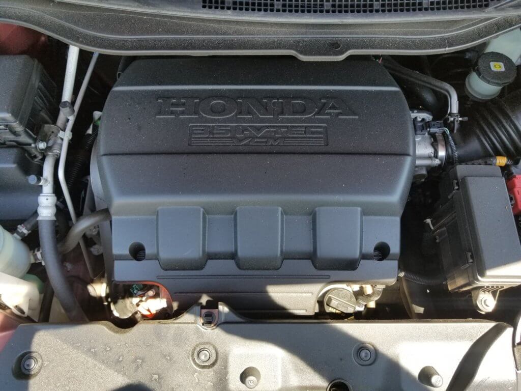 Honda Odyssey engine bay with oil fill cap and dip stick pictured