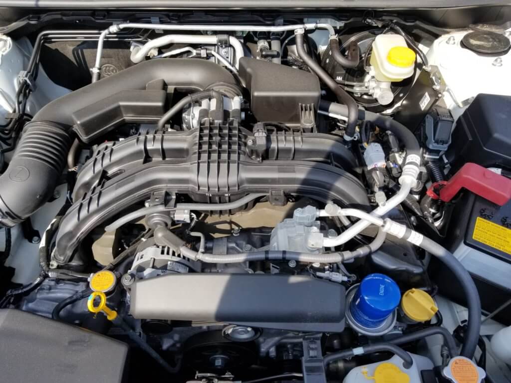 Subaru Crosstrek engine bay with oil filter, oil fill cap, and dipstick pictured