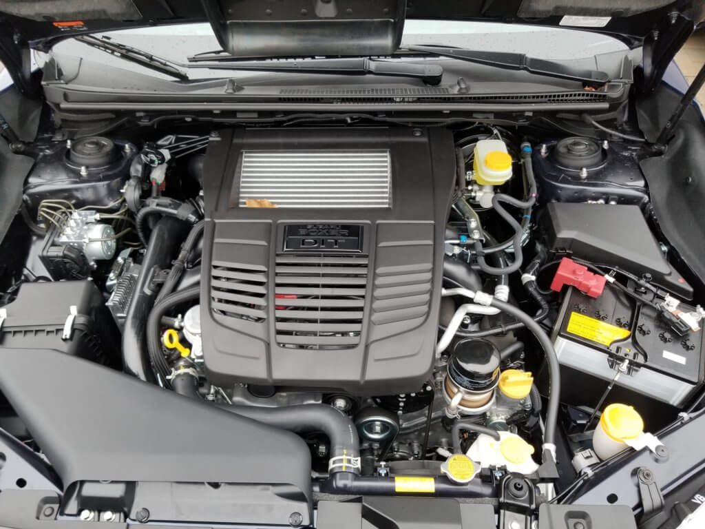 Subaru WRX engine bay with engine oil filter, engine oil fill cap and dip stick pictured
