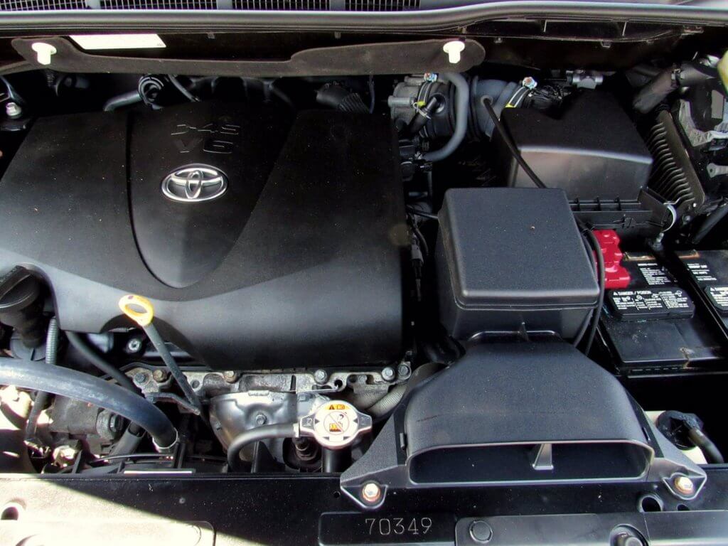 Toyota Sienna engine bay with engine oil dip stick pictured.