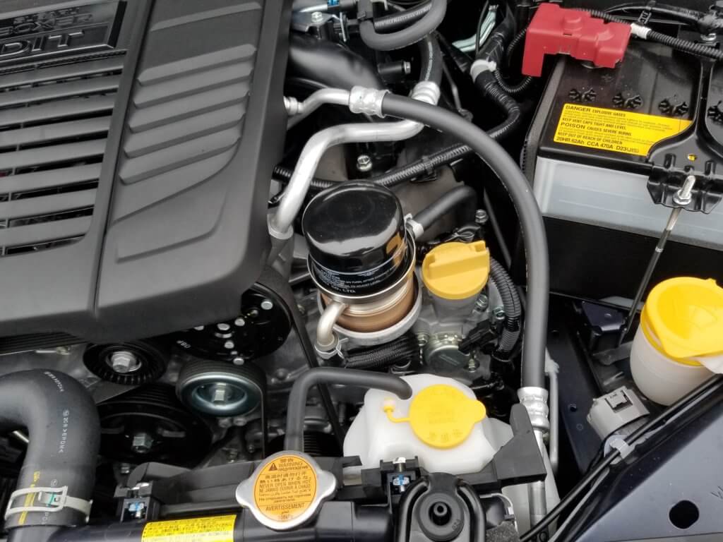 Subaru WRX engine oil filter housing and oil fill cap