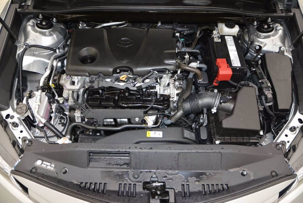 Toyota Camry 2.5L engine bay with oil fill cap and dip stick pictured