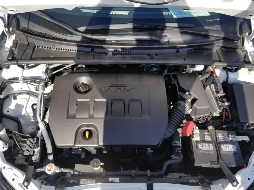 Toyota Corolla engine bay with engine oil fill cap and dip stick