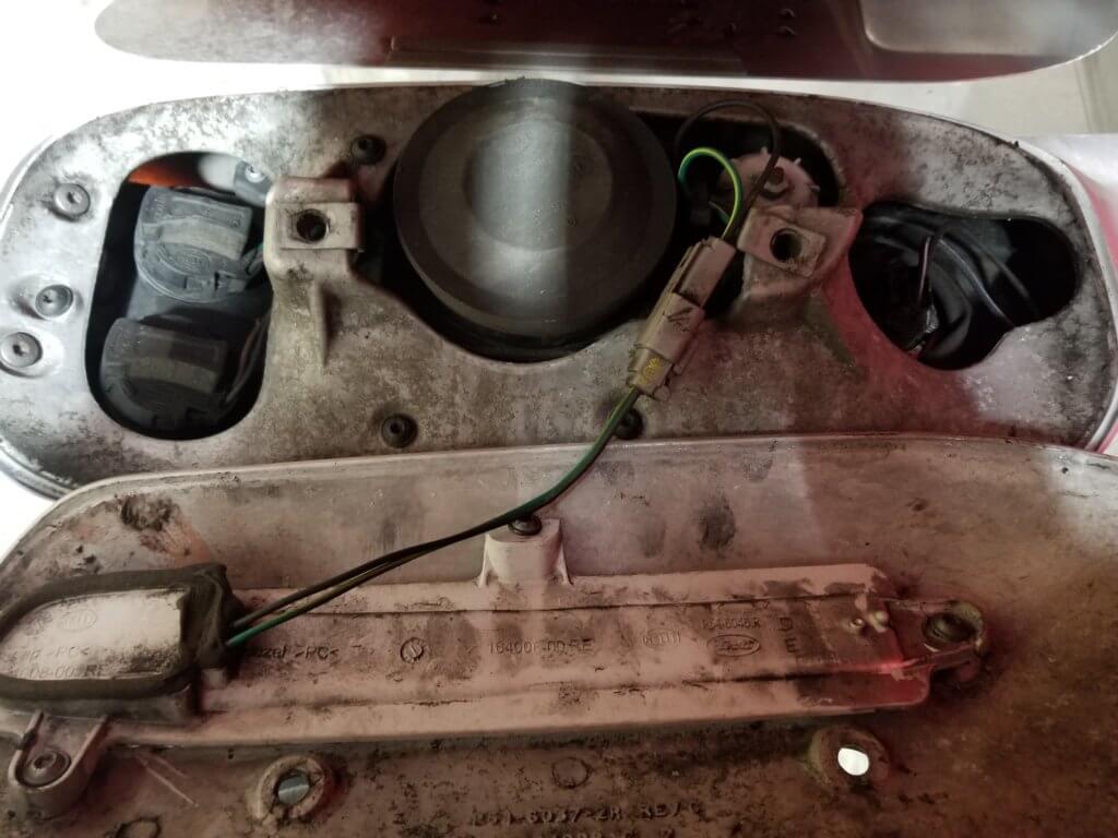 Peterbilt 389 headlight housing after cover is removed with wire connector still connected