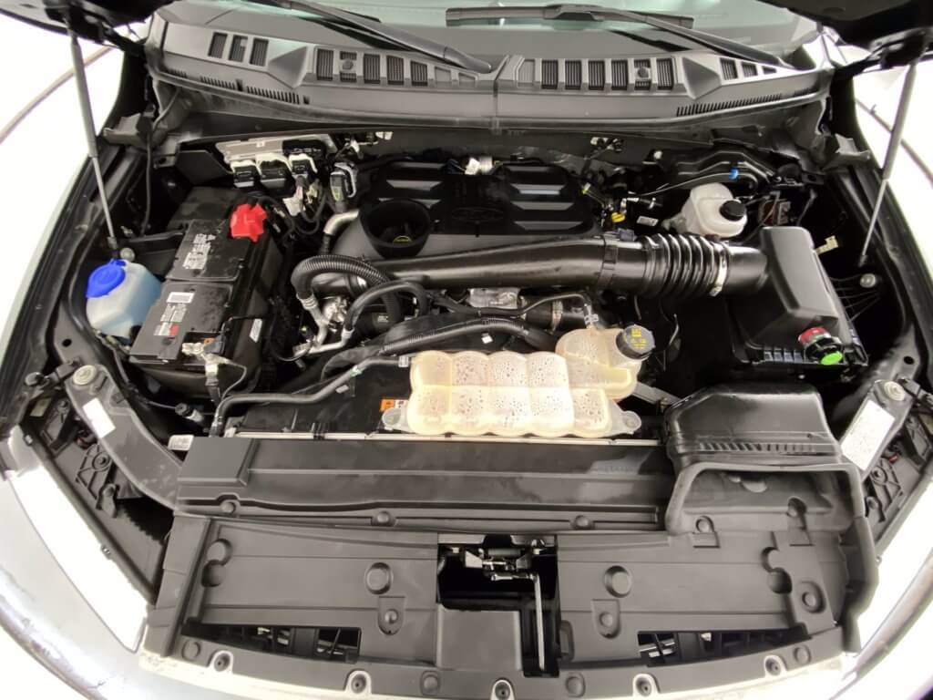 Ford F150 3.0L Powerstroke Diesel engine bay with the engine oil fill cap, dipstick and oil filter cover pictured