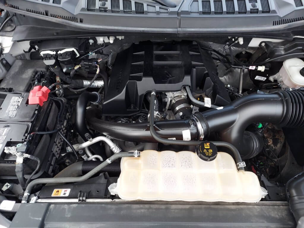 Ford F150 2.7 EcoBoost engine bay showing the engine oil fill cap, engine oil filter housing and dipstick