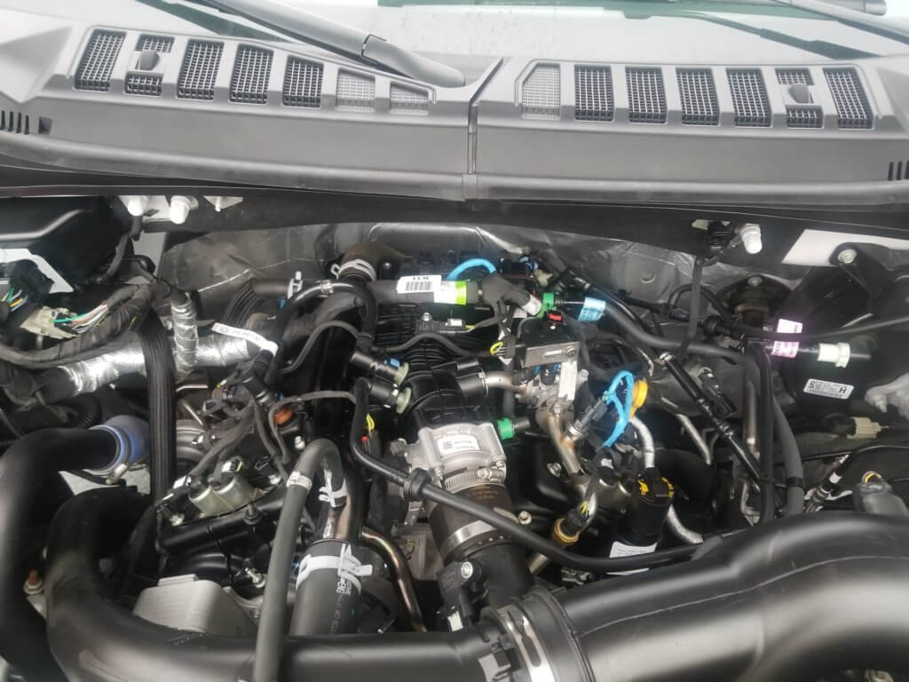 Ford F-150 3.3L engine bay with engine oil fill cap and dip stick pictured