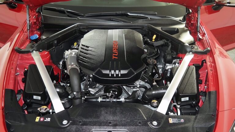 Kia Stinger 3.3L engine bay with engine oil fill cap and dip stick pictured